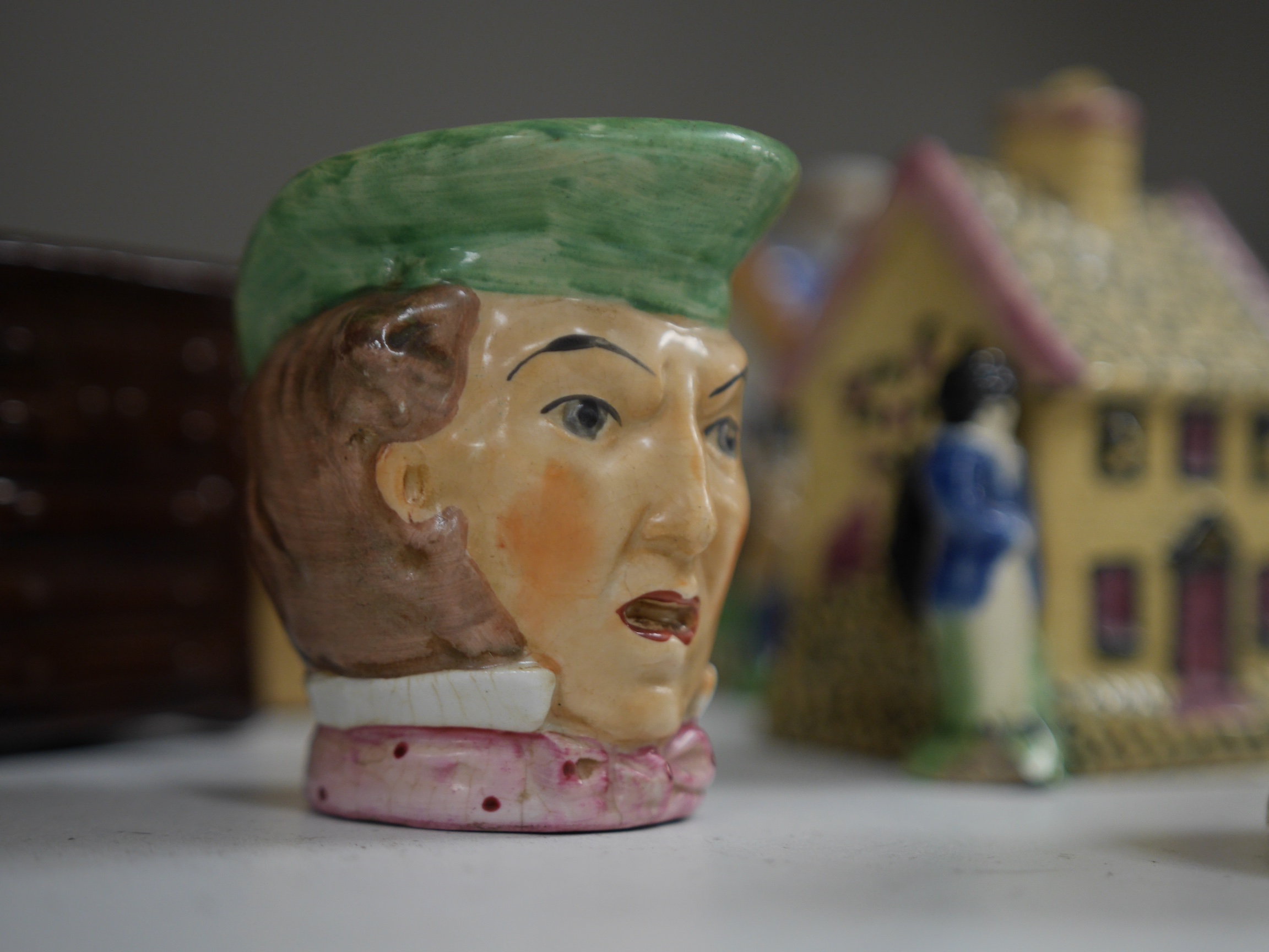 A group of ten novelty money boxes, including Staffordshire and glazed pottery money boxes, tallest 12.5cm high. Condition - two items chipped